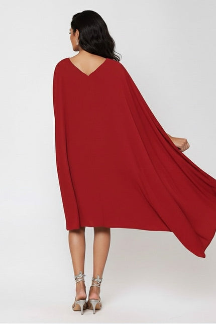Red cape dress worn by a person on a white background