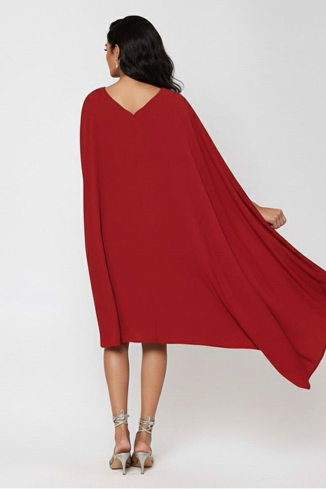 Red cape dress worn by a person on a white background