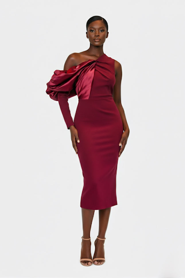 Woman wearing a burgundy one-shoulder dress on a white background