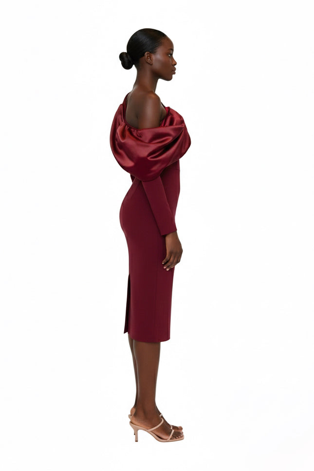 Woman wearing a burgundy off-shoulder dress on a white background