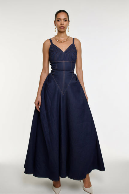 Woman wearing a navy blue dress on a white background