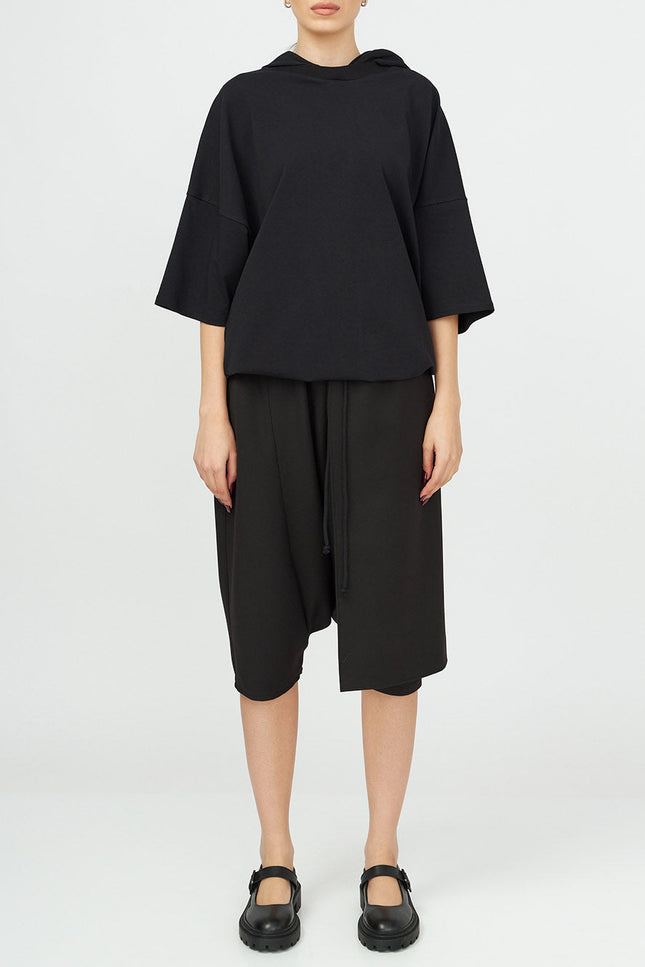Unisex Hooded Top
Details: 
Black cotton T-Shirt
short sleeve 
hood 
ribbed neckline 
adjustable hem 
Composition:

Cotton 96% Elastane 4% 
Washing instructions
Dry Clean Only
FittinShirts & TopsAlchemy The LabelAlchemy The LabelUnisex Hooded Top