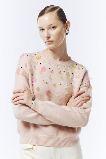 Close-up of iridescent sequin embellishments on SOUR FIGS pink jumper