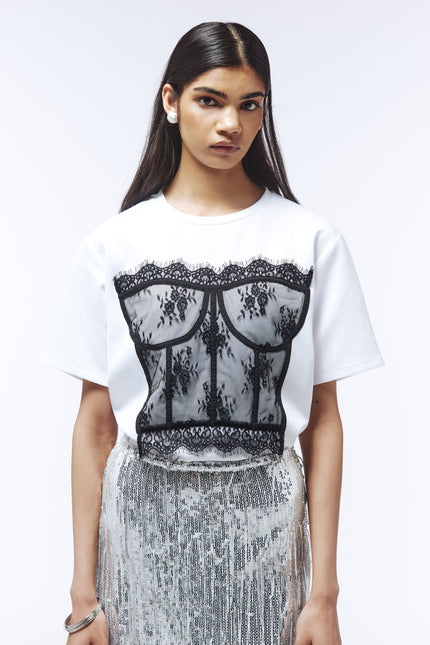Optical white tee featuring contrast floral lace bustier overlay