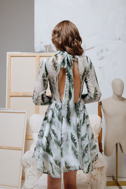 Back view of the dress featuring an elegant open-back design with an adjustable bow detail.