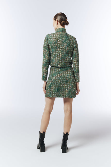 Back view of SOUR FIGS emerald tweed mini skirt styled with boots.