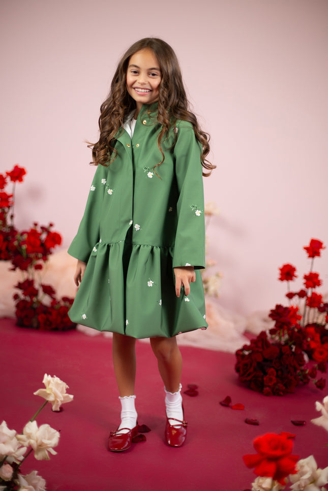 Girl model wearing a green floral coat with a hood, perfect for rainy weather