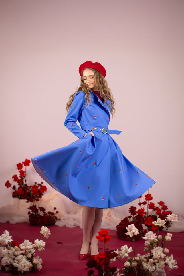 Stylish water-resistant coat featuring a fitted waist, golden-tone belt, and hidden pockets.