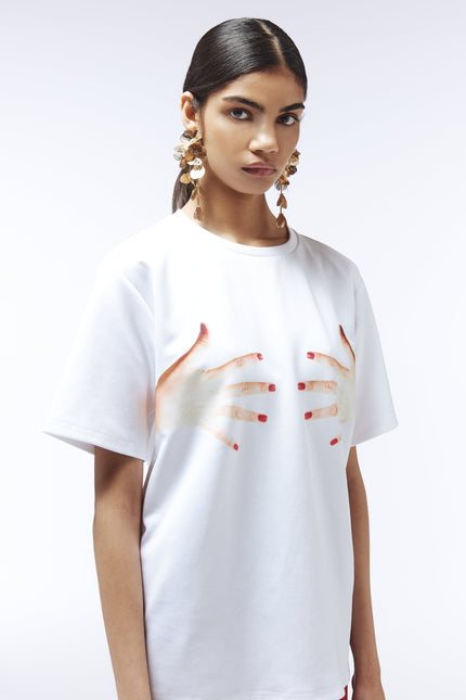 White graphic tee featuring red-painted hands, fashion statement top by Sour Figs
