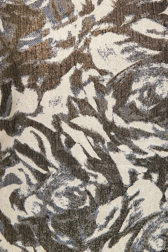 A close-up of Sarvin's Puff Shoulder Mini Dress shows its textured golden floral jacquard fabric with an abstract cream, brown, and gray pattern, slight sheen, and visible woven threads.