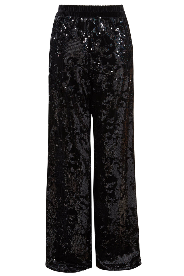Sarvin’s Sequin Velvet Flared Trousers are black, handmade in the UK, and feature a relaxed fit with an elastic waistband. Covered in glossy sequins for a reflective look, they’re the perfect party piece.