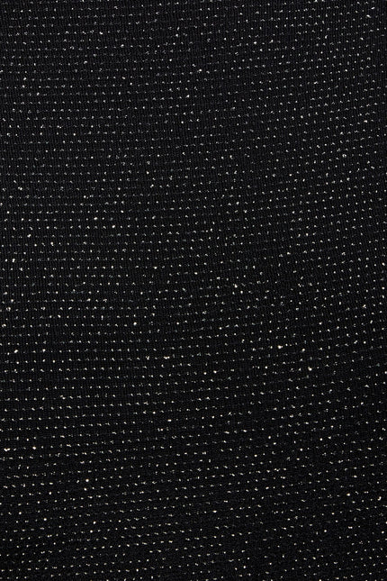 a close up of a Sarvin Black Cowl Back Gown with dots on it.