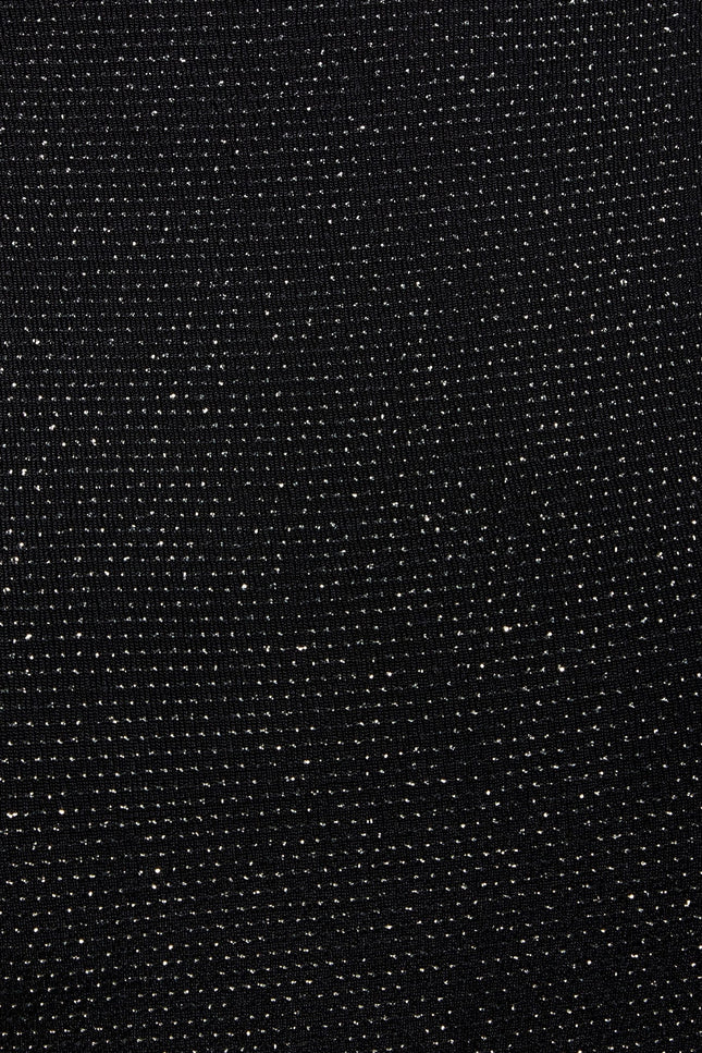 a close up of a Sarvin Black Cowl Back Gown with dots on it.
