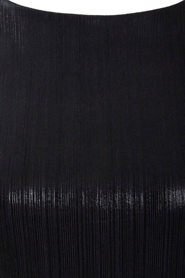 Close-up of the Sarvin Black Cut-Out Maxi Dress reveals finely ribbed fabric with a subtle sheen, vertical textured lines, and a smooth, curved upper edge—perfect for an elegant evening look.