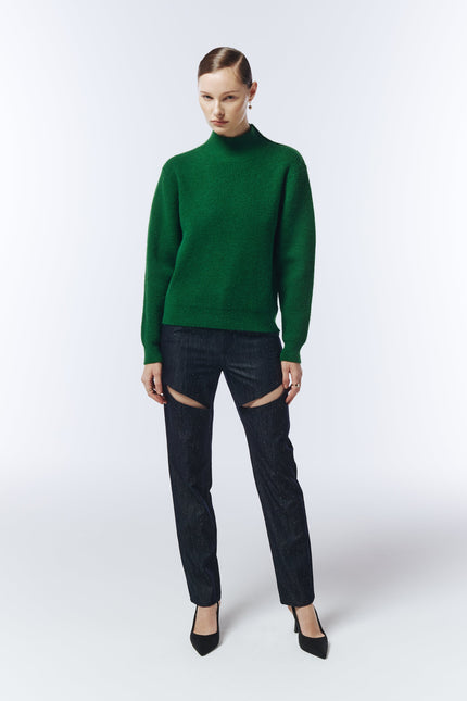 Model wearing SOUR FIGS Gold-Button Shoulder Jumper in Pine Green with dark trousers.