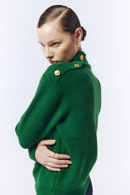 Editorial shot of model styling a pine green jumper