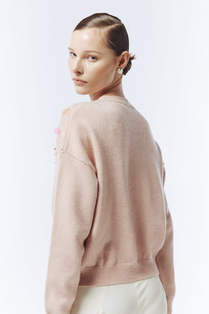 Back view of SOUR FIGS pink jumper highlighting relaxed silhouette and ribbed hem.