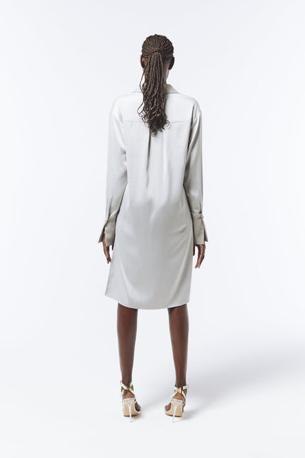 Silver satin shirt dress with asymmetric hem by SOUR FIGS – a contemporary take on timeless elegance.