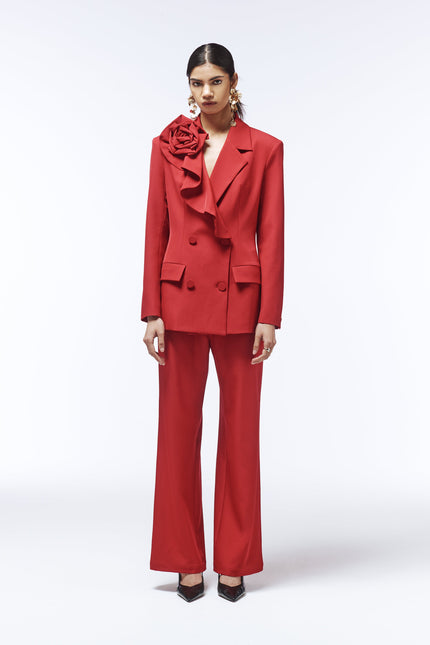 Editorial photo of model wearing SOUR FIGS Rose-Detail Double-Breasted Blazer in Vivid Burgundy Red with matching trousers.