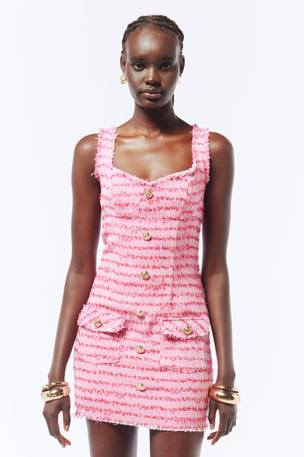 Classic meets contemporary in this pink tweed mini dress, designed with a V-neck, frayed edges, gold-tone buttons, and a flattering thigh-length cut.
