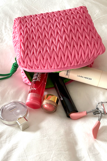 Pink squishy makeup bag by Lillyloves, soft and flexible wash bag with a cute, textured surface for storing cosmetics.