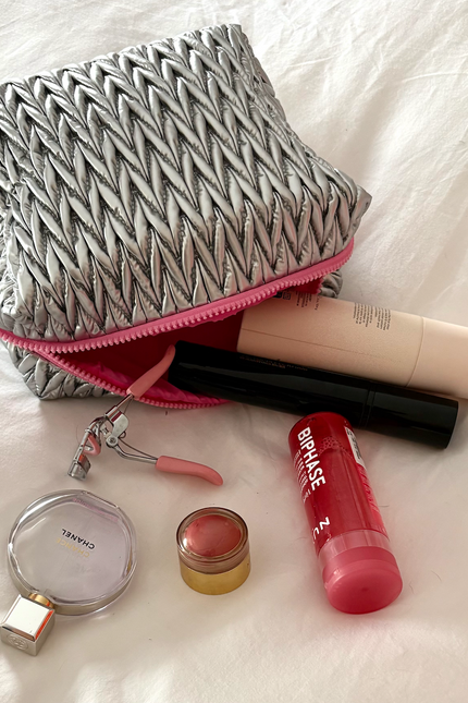 Silver squishy makeup bag by Lillyloves, a soft and flexible wash bag with a shiny metallic finish and zipper closure.