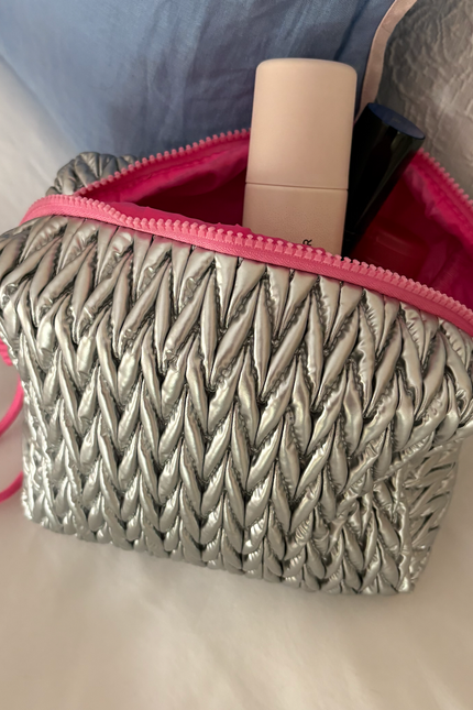 Silver squishy makeup bag by Lillyloves, soft silicone wash bag with a smooth, flexible texture for cosmetics storage.