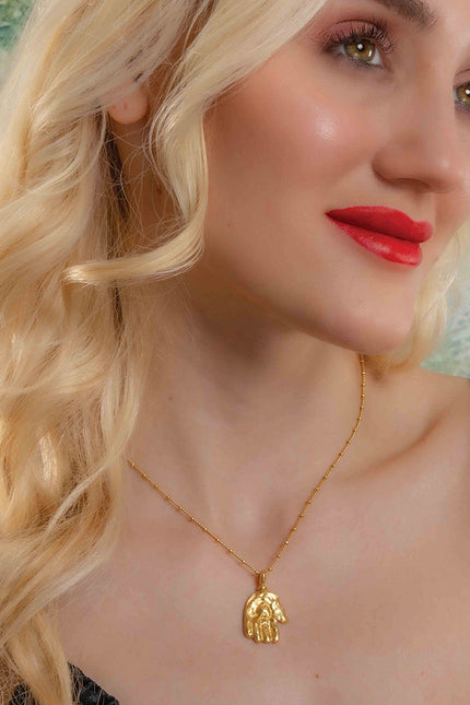 Model Wearing a gold plated Sculpted Hand Charm necklace by Arvion. Best Demi Fine Jewelry By Arvino