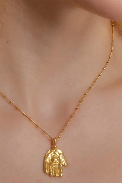 Model Wearing Sculpted Hand Charm Necklace In 925 Sterling Silver By Arvino