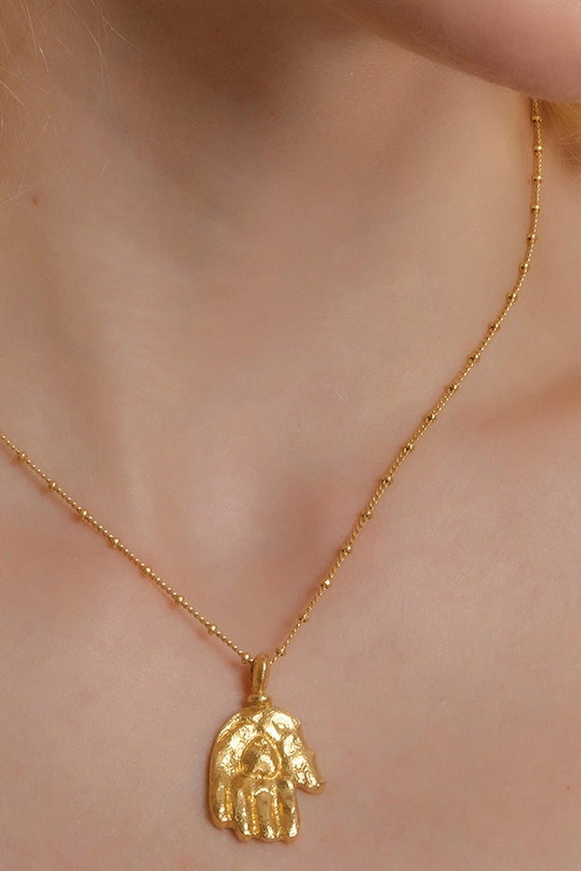 Model Wearing Sculpted Hand Charm Necklace In 925 Sterling Silver By Arvino