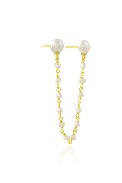 Pearl earcuff with gold chain on a white background