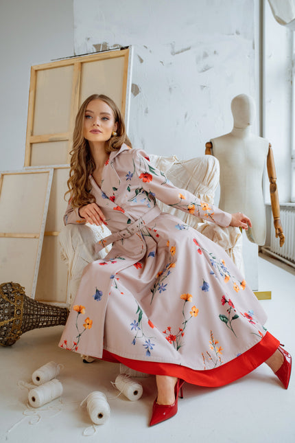 Beige waterproof coat with colorful flower print, double-breasted style and long skirt.