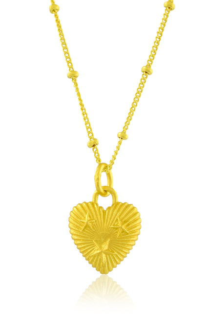 Gold heart-shaped pendant necklace on a white background