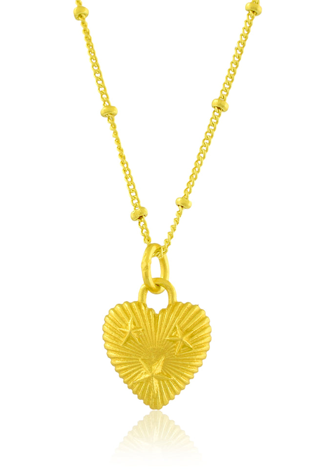 Gold heart-shaped pendant necklace on a white background