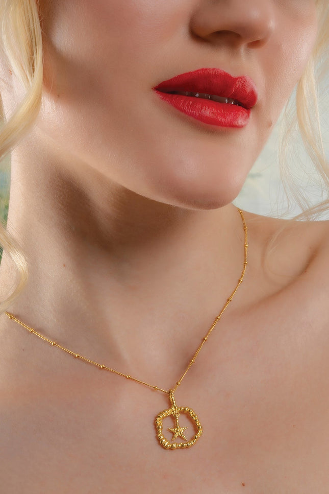 Model Wearing a Gold plated Sterling Silver star necklace by arvino