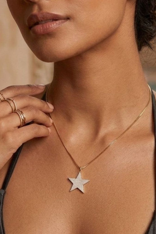 Woman wearing a star-shaped necklace with a blurred background