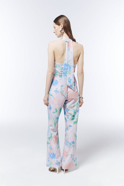 SOUR FIGS pastel floral jumpsuit featuring a plunging halterneck, twist-front waist and butterfly print.
