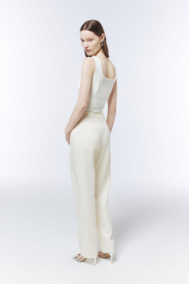 SOUR FIGS sleeveless white floral appliqué top styled with tailored ivory trousers.
