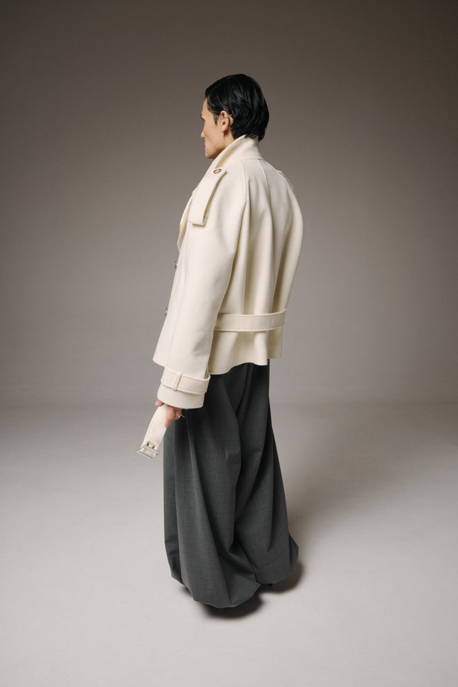 This Wool Short Coat defines effortless elegance with a modern, sculptural edge.