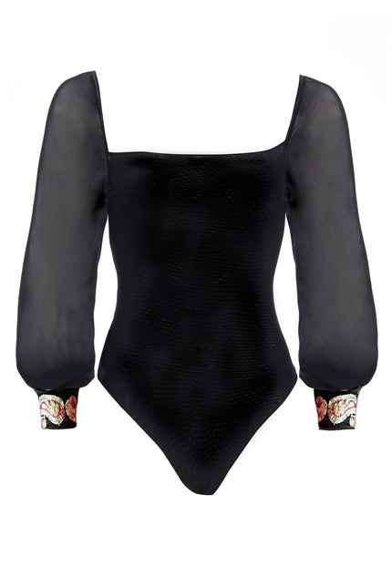 The Sarvin Black Mesh Bodysuit features sheer long puffed sleeves, a square neckline, textured fabric, and embellished cuffs with a colorful floral pattern for an elegant touch.