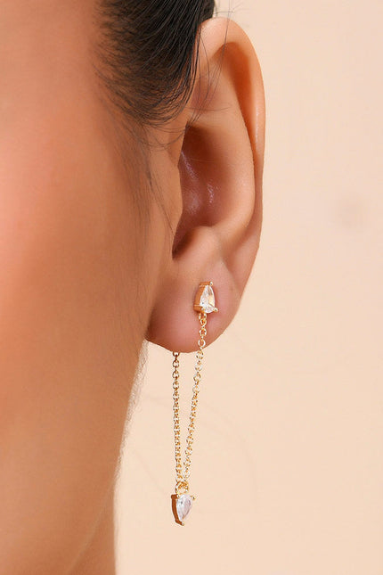 A close-up image of a woman's ear wearing a gold-Plated earring with a Zircon at the end.