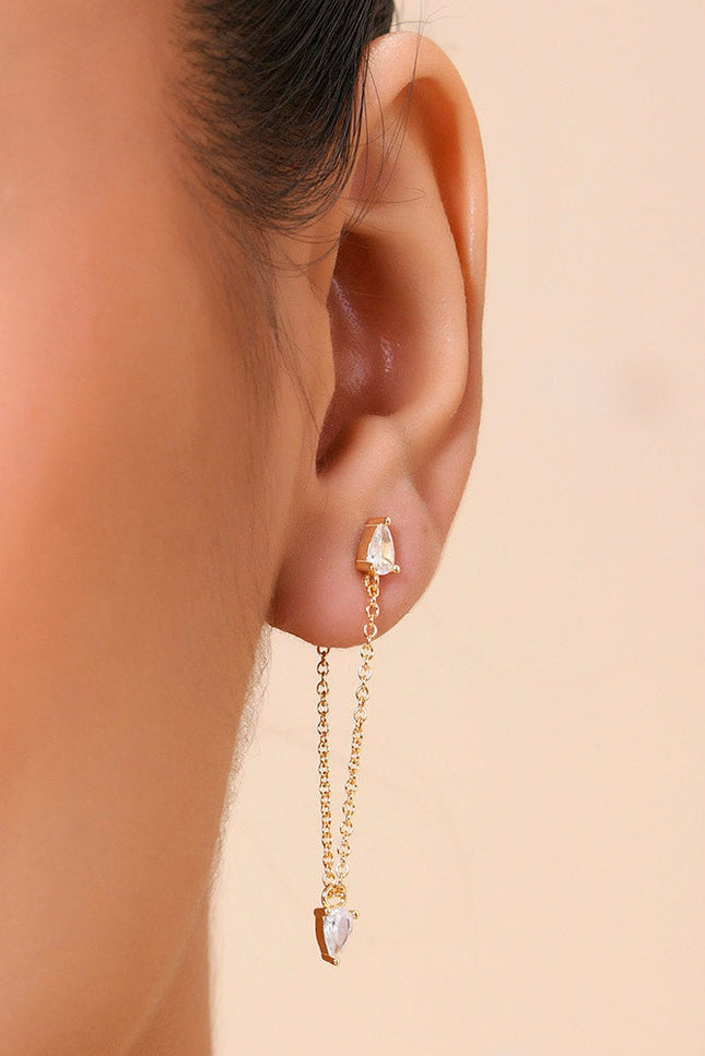 A close-up image of a woman's ear wearing a gold-Plated earring with a Zircon at the end.