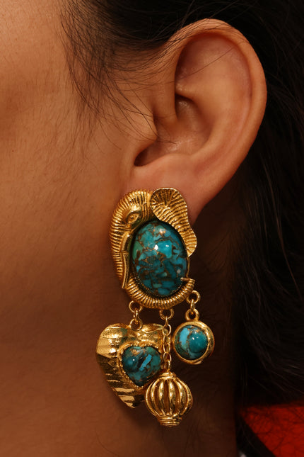 Close up shot of Arvino Turquoise Dream Danglers Earrings made up in 925 sterling and gold plated