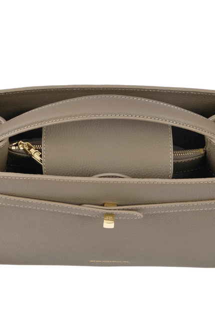 Open beige atelier galin cube lock handbag with gold logo hardware on a white background