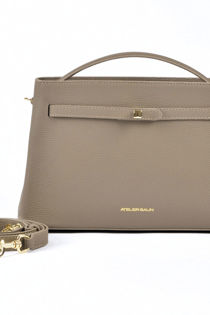 beige-mink-leather-mid-range-bag-brands atelier-galin-cube-lock handbag with a matching strap on a white background