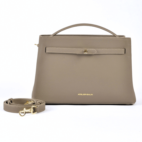 beige-mink-leather-mid-range-bag-brands atelier-galin-cube-lock handbag with a matching strap on a white background