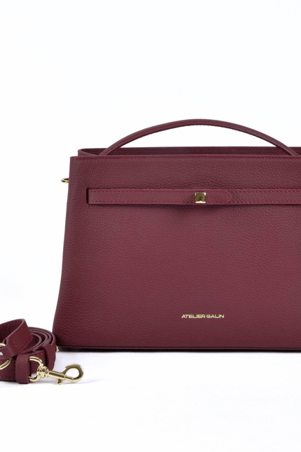 burgundy red leather atelier galin handbag with gold cube lock with detachable strap