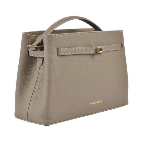 Beige atelier-galin-cube-lock-bag  handbag with gold accents on a white background