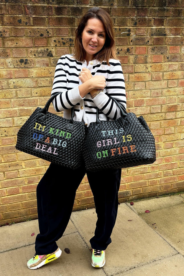 Lilly Loves "This Girl Is On Fire" handbag featuring bold flame design and stylish leather accents.