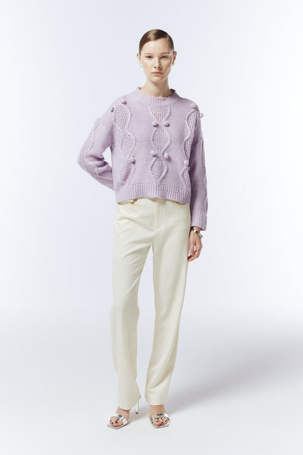 Soft lilac cable and bobble-knit jumper on model, front view showing relaxed fit and long sleeves.